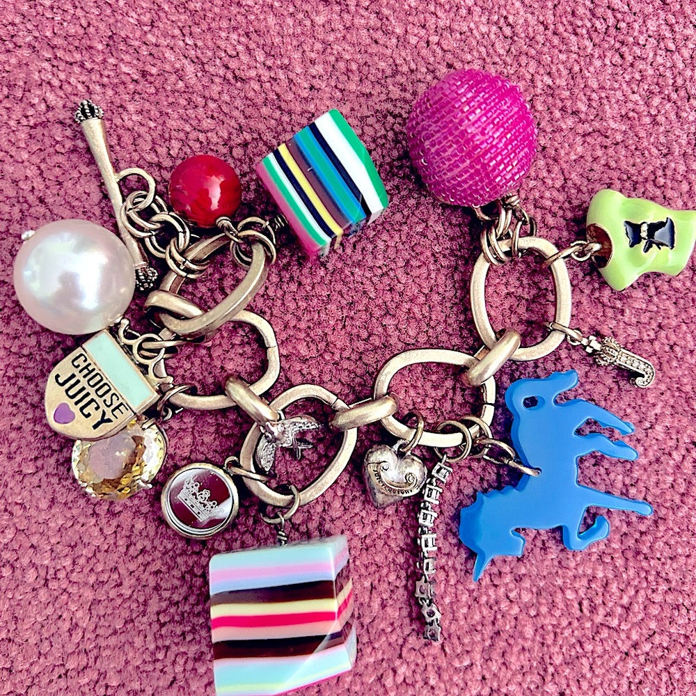 Authentic JC fun bracelet, in mint condition. It contains 13 colourful charm